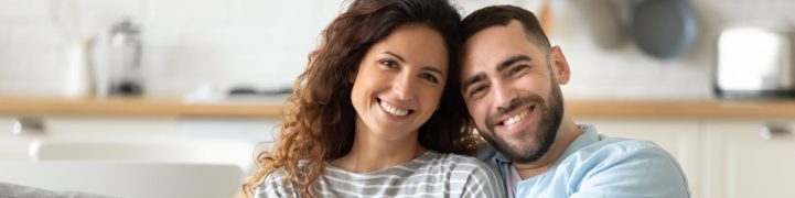 couple smiling on sofa